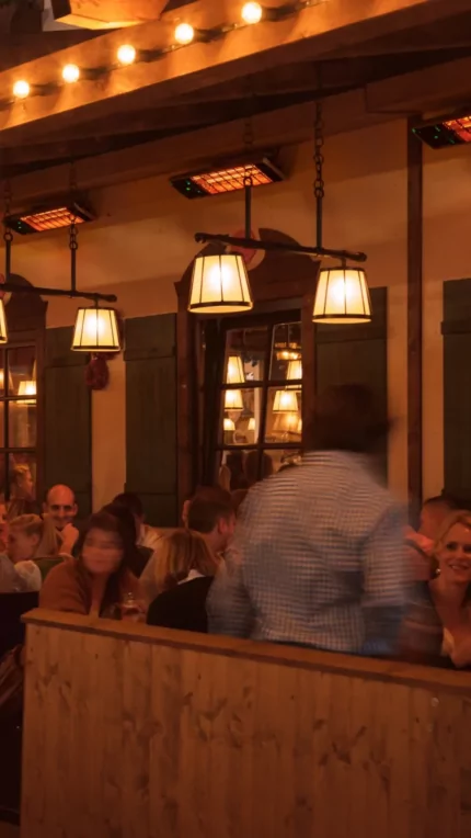 Heatscope Heaters Spot 2800W Radiant Heater wall-mounted on a restaurant terrace, outdoor electric infrared heating in Commercial Space.