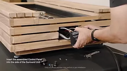 Inserting the assembled control panel into the surroundunit